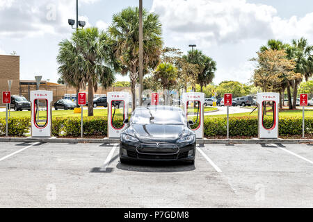 Homestead, USA - May 2, 2018: Closeup of Tesla Super Charging station in shopping mall with nobody, electric black car parked at parking lot Stock Photo