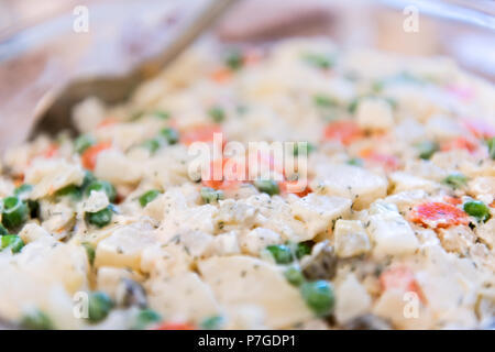 Traditional Ukrainian or Russian salad olivie, olivier macro closeup flat lay top view down with potatoes, carrots, mayonnaise, peas, dill Stock Photo