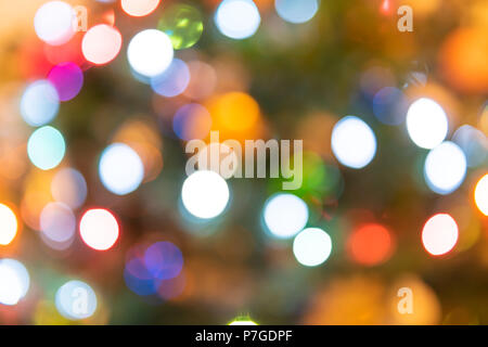 Background of blurred colorful, multicolored, multi-colored, Christmas ornament bokeh round circles of green, red, orange, blue colors Stock Photo
