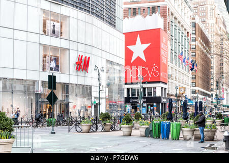 New York City, USA - April 6, 2018: Street view of urban NYC Herald Square Midtown with Macy's department store, H&M, people, pedestrians Stock Photo