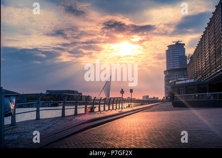 A beautiful celestial sunset over Salford Quays, sun rays shine, the light reflects off the floor to form a pleasing image. Stock Photo