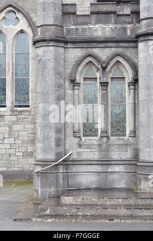 Arched windows with stained glass on stone early English style church in Ireland. Stock Photo