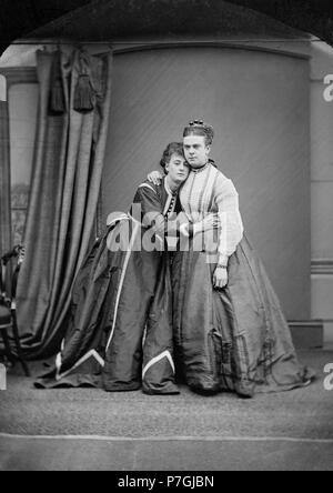 English: Female impersonators Frederick Park and Ernest Boulton. This photograph taken less than a year before their arrest by the Metropolitan Police for 'conspiring and inciting persons to commit an unnatural offence'. The original photograph is held by the Essex Record Office and an un-restored scan made available on their blog in February 2013. The photograph was used as a full page spread in Attitude (a UK gay lifestyle magazine) in August 2013, issue 234 and appears in a cropped form but otherwise unaltered in the book 'Fanny & Stella, The Young Men Who Shocked Victorian England' (2013)  Stock Photo