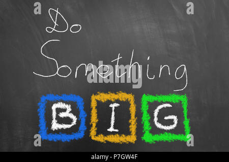 Do something big chalk text on blackboard or chalkboard as motivational inspiring optimistic vision message concept Stock Photo