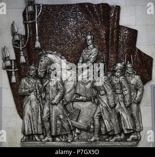 Mikhail Frunze (1885-1925). Bolshevik leader. Major Red Army commander in the Russian Civil War. Relief depicting Frunze on horseback, surrounded by the Red Army. By the Russian sculptor Vladimir Sychyov (1917-1995). Aluminum and red glaze. Metro station of Frunzenskaya, Saint Petersburg. Russia. Stock Photo