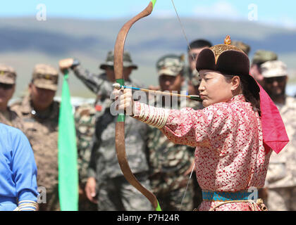 A traditional Mongolian archer shoots at a target during the Nadaam Festival as part of Khaan Quest 2018 at Five Hills Training Area, Mongolia, June 27.  KQ18 is a regularly scheduled, multinational exercise co-sponsored by U.S. Pacific Command and hosted annually by the Mongolian Armed Forces.  This exercise is the latest in a continuing series of exercises designed to promote regional peace and security.  This year's exercise marks the 16th anniversary of this training event.  (U.S. Army National Guard photo by Pfc. Grace Nechanicky/Released) Stock Photo