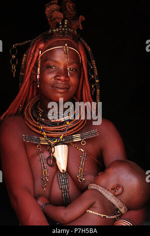 Married Himba woman breastfeeding her baby, Kunene District, Kaokoveld, Namibia Stock Photo