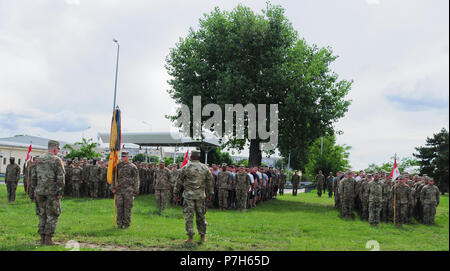 Lt. Col. Kelvin Swint, commander of the 2nd Battalion, 5th Cavalry Regiment, 1st Armored Brigade Combat Team, 1st Cavalry Division provides soldiers with words of wisdom following the promotion of 1st Lt. Steven Schworm assigned to 2-5 Cav, 1st ABCT, 1st CD at Mihail Kogalniceanu Air Base in Romania, June 29, 2018. Schworm originates from Spencerport, New York and is deployed with the 2-5 Cav in support of Atlantic Resolve, an enduring training exercise between NATO and U.S. Forces. (U.S. Army National Guard photo by Spc. Hannah Tarkelly, 382nd Public Affairs Detachment/ 1st ABCT, 1st CD/Relea Stock Photo