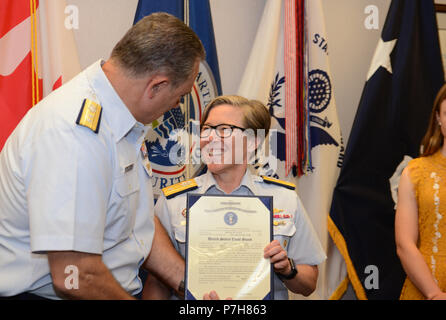 Rear Adm. Joanna Nunan, the Ninth District Commander, smiles as retired Rear Adm. Mike Parks, former Ninth District Commander presents her promotion certificate July 3, 2018 in Cleveland. Nunan was promoted from Rear Adm. Lower Half to Rear Adm. Upper Half. (U.S. Coast Guard photo by Petty Officer 2nd Class Christopher M. Yaw) Stock Photo