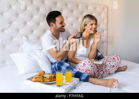 Young happy couple having having romantic times in bedroom Stock Photo