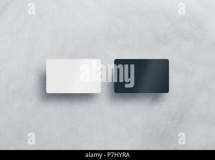 Two blank plastic business cards mockups set isolated on grey textured background. Black and white namecard design mock up presentation. Empty horizontal visiting sheets template with shadows. Stock Photo