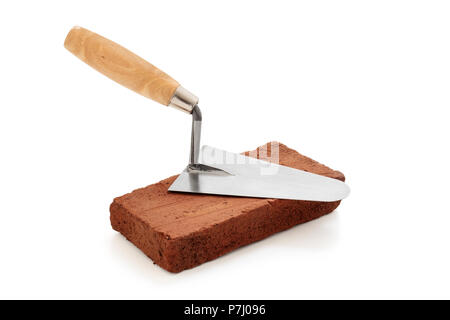 Brick and trowel isolated on white background. Stock Photo