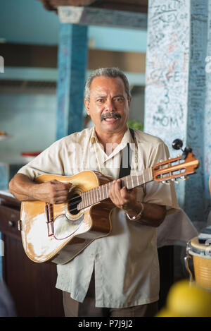 A band plays upbeat music in La Bodeguita del Medio, a popular restaurant and bar in Old Havana. It's most notable regular was Ernest Hemingway Stock Photo