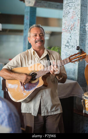 A band plays upbeat music in La Bodeguita del Medio, a popular restaurant and bar in Old Havana. It's most notable regular was Ernest Hemingway Stock Photo