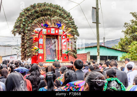 Parramos, Guatemala - December 28, 2016: Catholic procession with float decorated with peacock feathers near UNESCO World Heritage Site of Antigua. Stock Photo