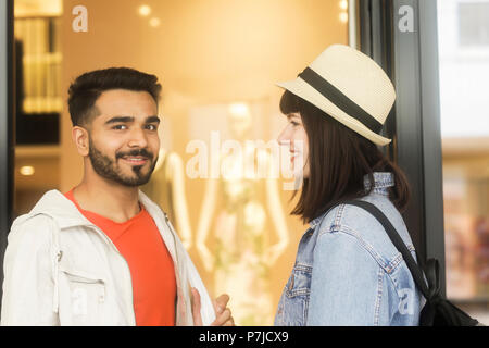 Smiling Couple standing outside a shop Stock Photo