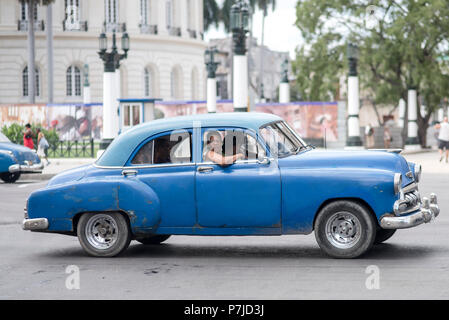 A beautiful, vintage American car sitting at a red light in Havana, Cuba. Stock Photo