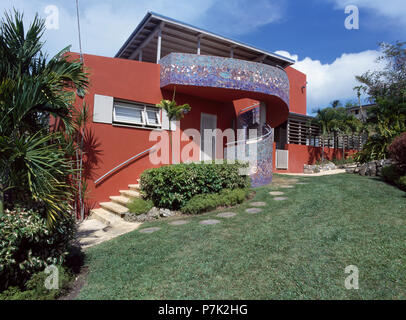 Blue mosaic tiled balcony on modern red house in the West Indies Stock Photo