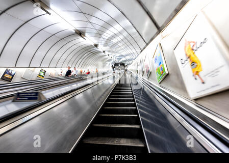 London, UK - June 26, 2018: People riding escalator up and down standing in Underground tube metro in Pimlico district area of city through tunnel Stock Photo