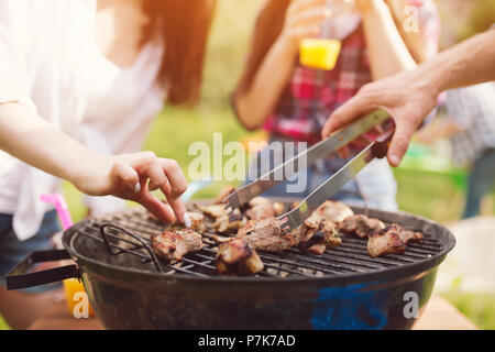 Meat frying on grill outdoors. Stock Photo
