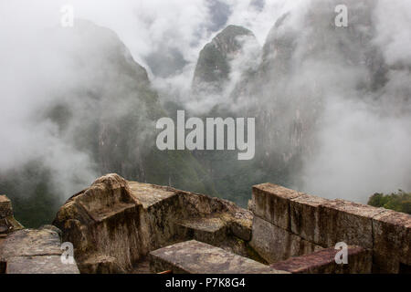 Beautiful image of Machu Picchu ruins and the clouds over the mountains on the background. Prize for hiking the Inca Trail. Peru. South America. No pe Stock Photo