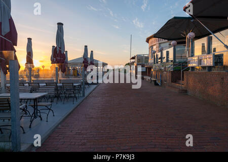 Germany, Lower Saxony, East Frisia, Juist, gastronomy on the beach promenade in the morning light. Stock Photo