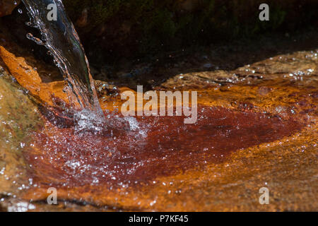 Larissa, Greece. 6th July, 2018. Curative red water flows from a spring at Kokkino Nero Village of Larissa in northeast Thessaly, Greece, July 6, 2018. Curative red water attracts visitors from all over the world looking for bath therapy along with mineral water drinking therapy. Credit: Apostolos Domalis/Xinhua/Alamy Live News Stock Photo