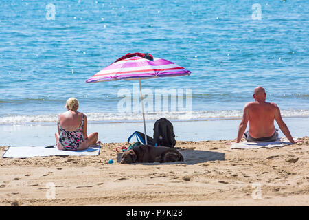 Bournemouth, Dorset, UK. 7th July 2018. UK weather: another hot sunny day as the heatwave continues and thousands of sunseekers head to the  seaside to enjoy the sandy beaches at Bournemouth. Mature couple sunbathing on the seashore. Credit: Carolyn Jenkins/Alamy Live News Stock Photo