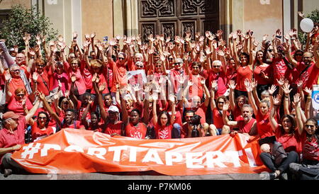 TURIN, ITALY  7th July  2018: FLASH MOB 'A red T-shirt to stop the bleeding of humanity'. Flash mob that was held at the same time throughout Italy to demonstrate in favor of migrants, especially children. Red is the color of the shirts of children who die at sea to reach Europe. Of red were dressed the three children drowned and whose bodies without life were recovered last June 29 in front of the Libyan coasts. Of red will be dressed more by the mothers, in the hope that, in the event of shipwreck, that color recall the attention of the rescuers.Credit: Michele D'Ottavio/Alamy Live News Stock Photo