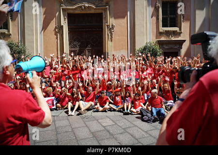 TURIN, ITALY  7th July  2018: FLASH MOB 'A red T-shirt to stop the bleeding of humanity'. Flash mob that was held at the same time throughout Italy to demonstrate in favor of migrants, especially children. Red is the color of the shirts of children who die at sea to reach Europe. Of red were dressed the three children drowned and whose bodies without life were recovered last June 29 in front of the Libyan coasts. Of red will be dressed more by the mothers, in the hope that, in the event of shipwreck, that color recall the attention of the rescuers.Credit: Michele D'Ottavio/Alamy Live News Stock Photo