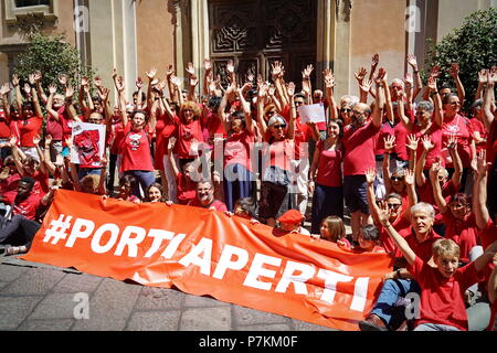 TURIN, ITALY  7th July  2018: FLASH MOB 'A red T-shirt to stop the bleeding of humanity'. Flash mob that was held at the same time throughout Italy to demonstrate in favor of migrants, especially children. Red is the color of the shirts of children who die at sea to reach Europe. Of red were dressed the three children drowned and whose bodies without life were recovered last June 29 in front of the Libyan coasts. Of red will be dressed more by the mothers, in the hope that, in the event of shipwreck, that color recall the attention of the rescuers.Credit: Michele D'Ottavio/Alamy Live News Stock Photo