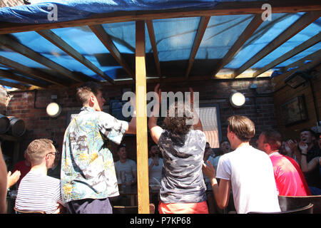 Manchester, UK. 7th July 2018.  Football supporter celebrating England score a goal in the World Cup quarter final against Sweden at Fred alehouse, Levenshulme Credit: Gerard Noonan/Alamy Live News Stock Photo