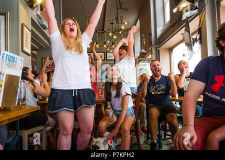 Wales, UK. 7th July 2018. World Cup 2018 : In the White Horse pub , Aberystwyth, happy England fans celebrate their team winning 2-0 against Sweden, and securing their place in the semi finals for the first time in 28 years.   Photo © Keith  Morris / Alamy Live News Stock Photo