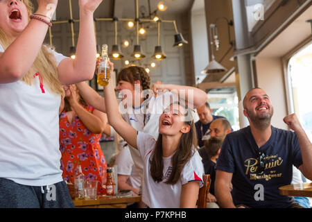 Wales, UK. 7th July 2018. World Cup 2018 : In the White Horse pub , Aberystwyth, happy England fans celebrate their team winning 2-0 against Sweden, and securing their place in the semi finals for the first time in 28 years.   Photo © Keith  Morris / Alamy Live News Stock Photo