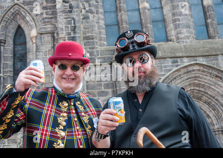 Paisley, Scotland, UK. 7th July, 2018. Two men dressed in steampunk costumes celebrating Sma' Shot Day in the parade travelling through the streets of Paisley from Brodie Park to Abbey Close. Sma' Shot Day takes it's name from a famous victory between the shawl weavers and the Cork (the middle man) in the 19th Century. The sma' shot is a fine weft yarn, woven into Paisley shawls by the weavers, for which they were not paid. In 1856 an agreement was finally  reached to pay for the sma' shot. Credit: Skully/Alamy Live News Stock Photo