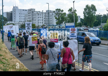 London, UK. 7th July 2018. Keep Our St Helier Hospital (KOSHH) campaigners against the closure of acute facilities at Epsom and St Helier Hospitals in south London celebrating the 70th Birthday of the NHS with a march from Sutton arrive at St Helier Hospital for a rally.   he of so Credit: Peter Marshall/Alamy Live News Stock Photo