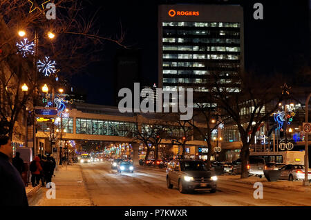 WINNIPEG, CANADA - 2014-11-20: Night view on Christmas decorated Portage Avenue, also known as Route 85. It is a part of Trans-Canada Highway and major route of the Canadian city of Winnipeg, Manitoba Stock Photo