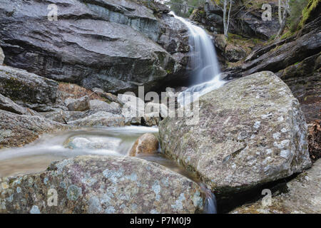 Bridal Veil Falls on Coppermine Brook in Franconia, New Hampshire during the spring months. This waterfall looks great during the spring snowmelt and  Stock Photo