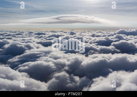 Lenticular cloud above highest cloud layer, cumulus lenticularis, clouds and sun, cloud flying above northern North Rhine-Westphalia, clouds and blue sky, diffuse sun in blue sky, Neuenkirchen, North Rhine-Westphalia, Germany Stock Photo