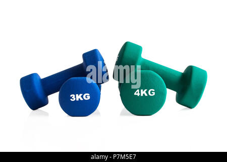 Blue and green gym dumbbells isolated on a white background. Stock Photo