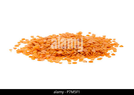 Isolated uncooked red lentils on white background. Stock Photo