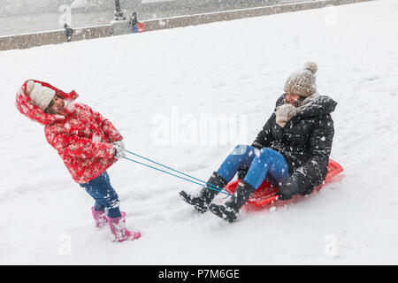 England, London, Southwark, Potters Field, Mother and Child Playing in the Snow Stock Photo