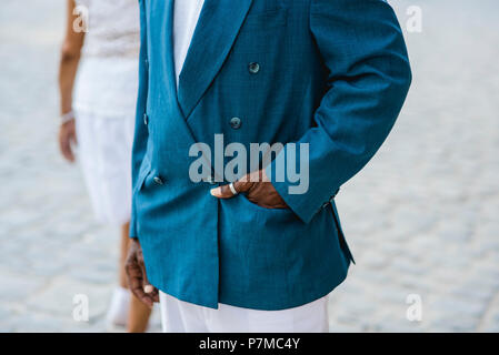 An impeccably dressed man smoking a giant cigar on the streets in Havana, Cuba. He was featured in National Geographic Traveler years ago. Stock Photo