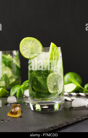 One shot of mojito cocktail in glass on black table. Low key photo. Close up. Stock Photo
