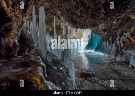 Ice stalactites in a cave at the shore at lake Baikal, Irkutsk region, Siberia, Russia Stock Photo