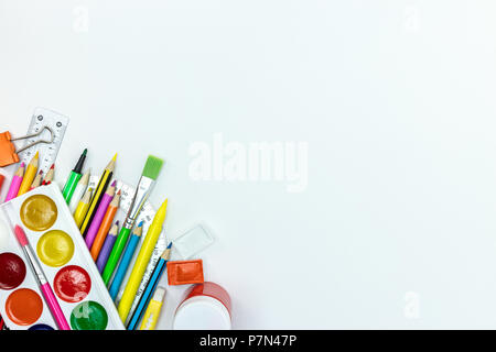 bright school supplies and accessories for kids on white desk surface background, flat lay Stock Photo