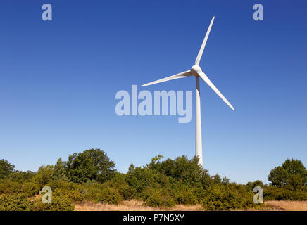 Wind turbine against a blue sky. Stock Photo