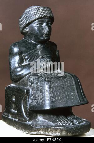 Gudea, prince of Kingdom of Lagash. Seated statue dedicated to the god Ningishzida. C. 2120 BC. Diorite. Louvre Museum. Paris. France. Stock Photo