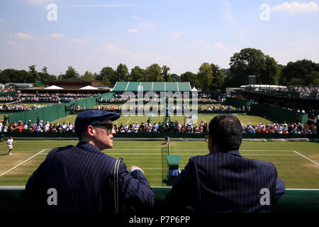 Line judges watch the action on the outside courts on day six of the Wimbledon Championships at the All England Lawn Tennis and Croquet Club, Wimbledon. Stock Photo