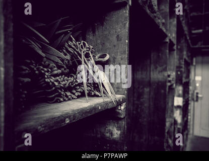 old workshop with rusty iron tools and scissors with gloomy admonsphere Stock Photo